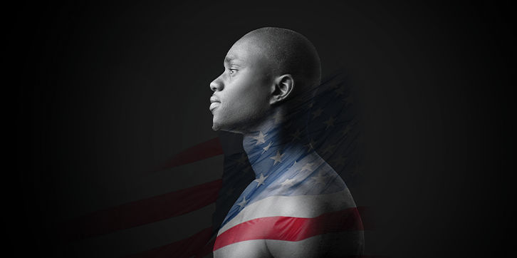 Black background with a profile photo of a strong young black man with bare skin from the chest up in the center. The man's expression shows neither joy, nor sorrow. This photo is overlayed with a transparent American flag in mid wave wrapping across the man's neck and chest.