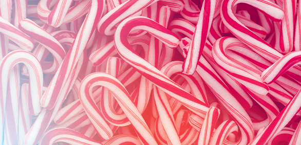 Photo of red and white candy canes piled so high you cannot see the surface below. A Family Christmas is a sweet and exciting experience for children.