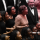 Members of Choral Arts and Washington Performing Arts Gospel Choirs singing on stage with fervent emotion.