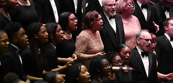 Members of Choral Arts and Washington Performing Arts Gospel Choirs singing on stage with fervent emotion.